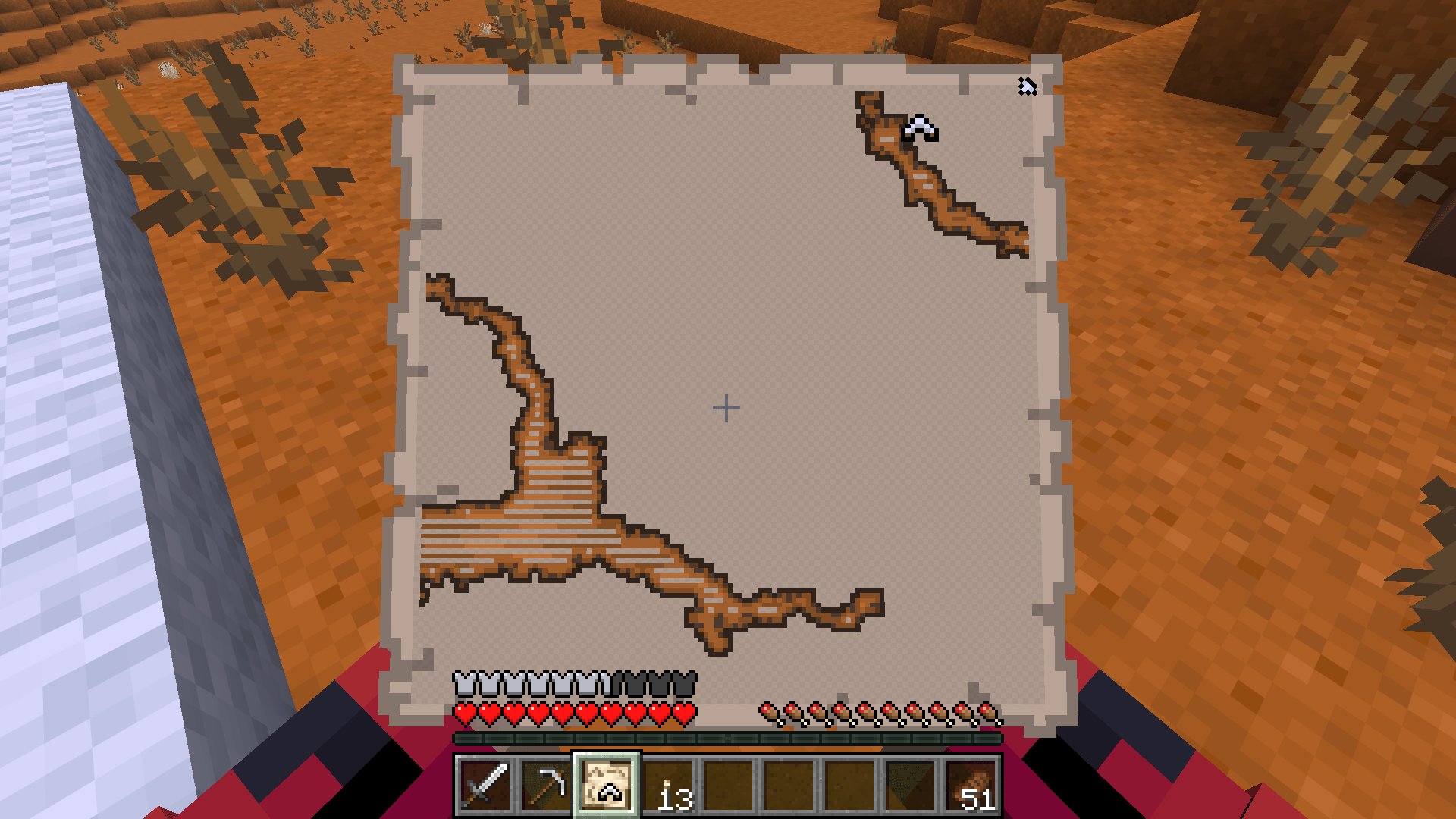 A Minecraft Abandoned Camp chest, an Explorer Map found inside, and the map opened in the player's hand.